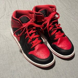 Black, red and white Nike Air Jordan high top basketball shoes